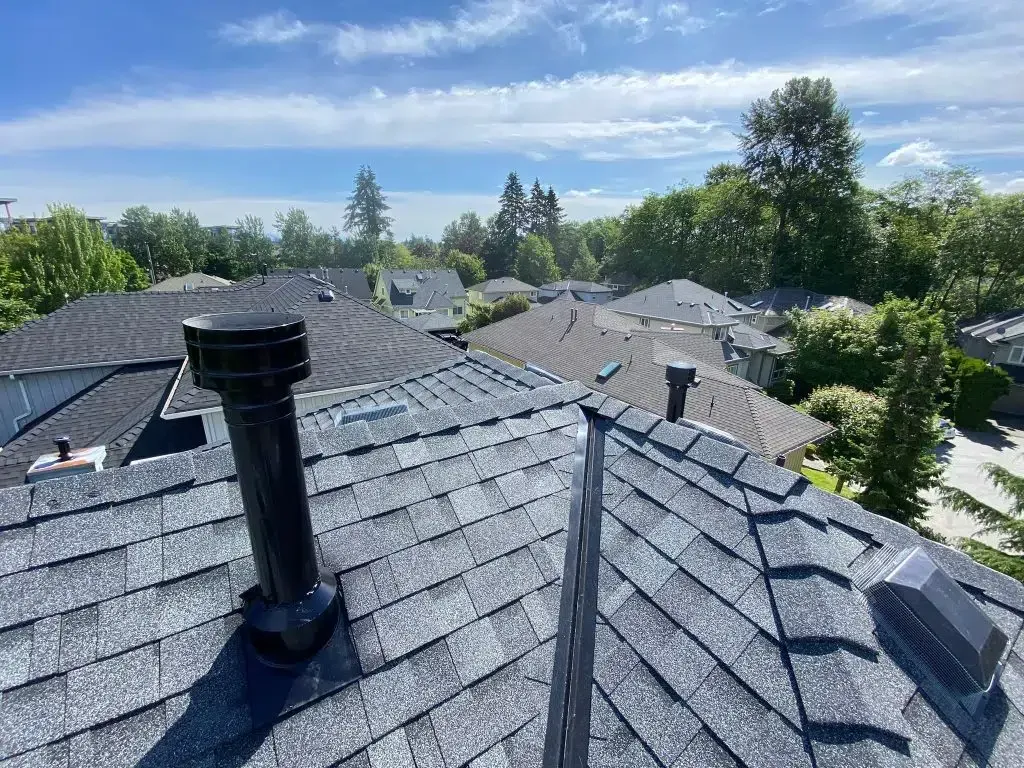 The roof of a house with a chimney on it.