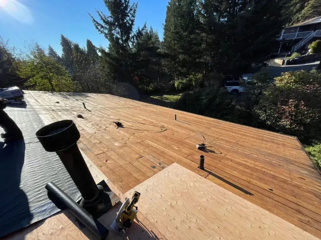 A wooden deck is being built on top of a wooden roof.