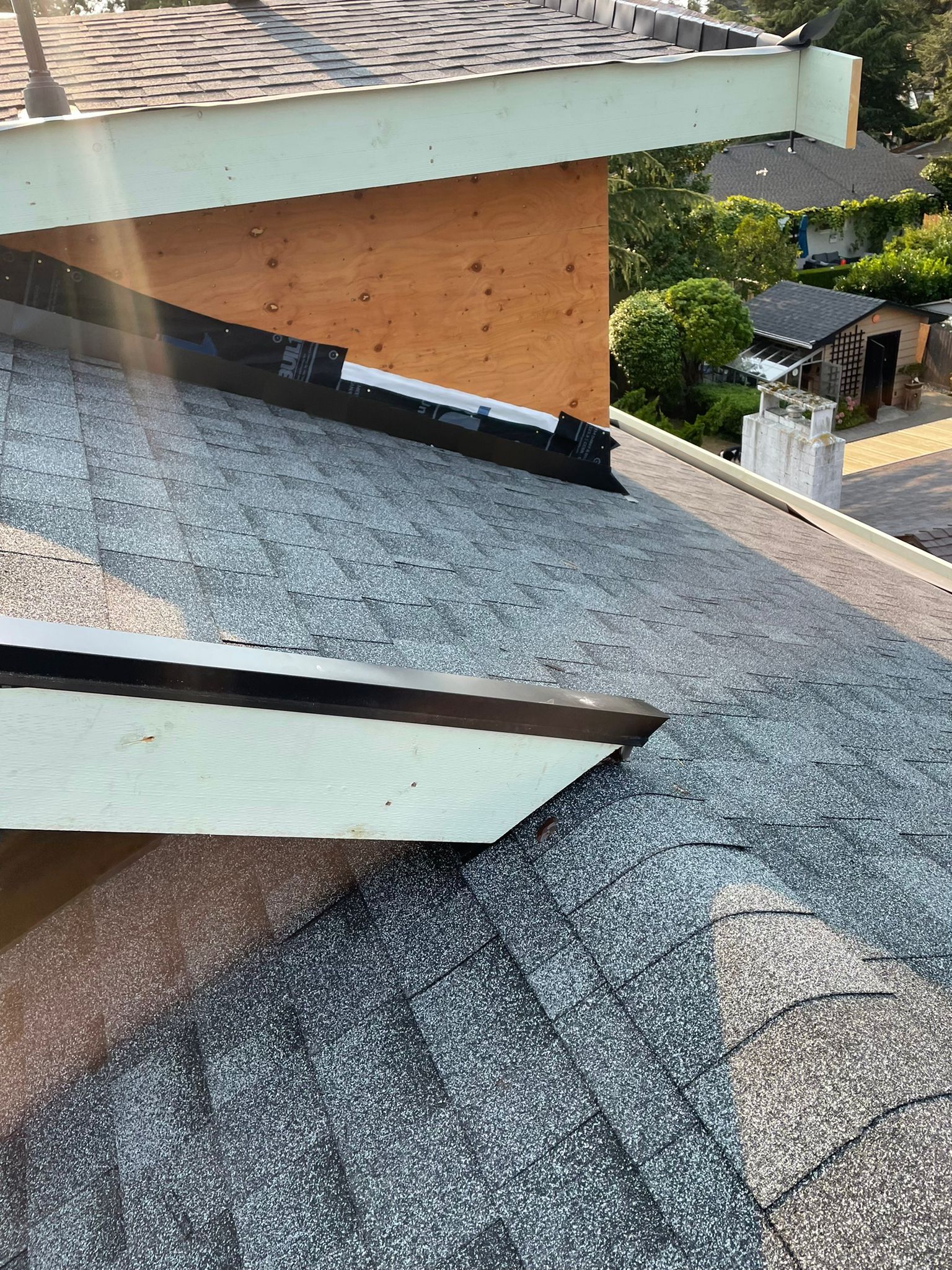 A close up of a roof with a chimney on it.