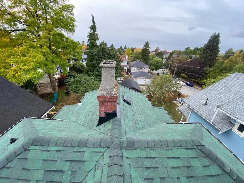 An aerial view of a roof with a chimney on it.