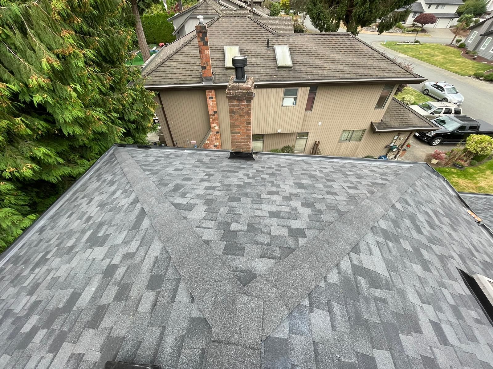 An aerial view of a roof of a house with a chimney.