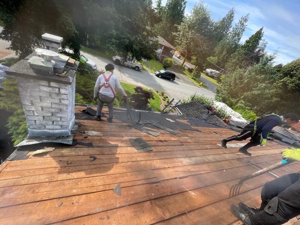 A group of people are working on a roof.