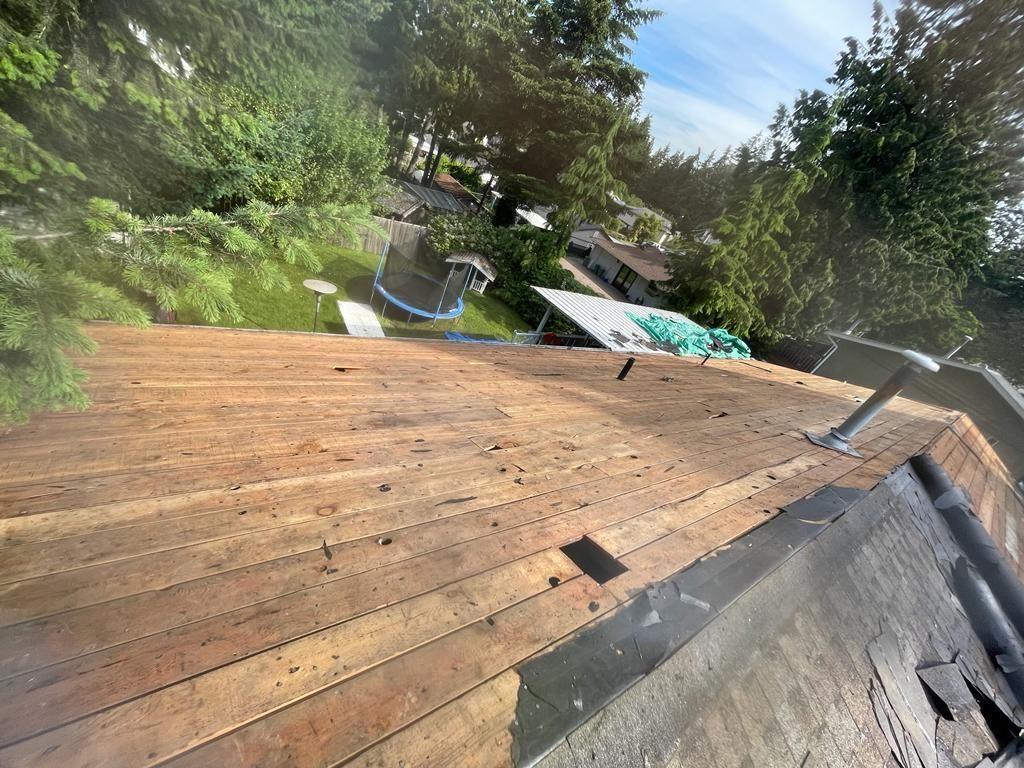 A wooden deck is being built on top of a roof.