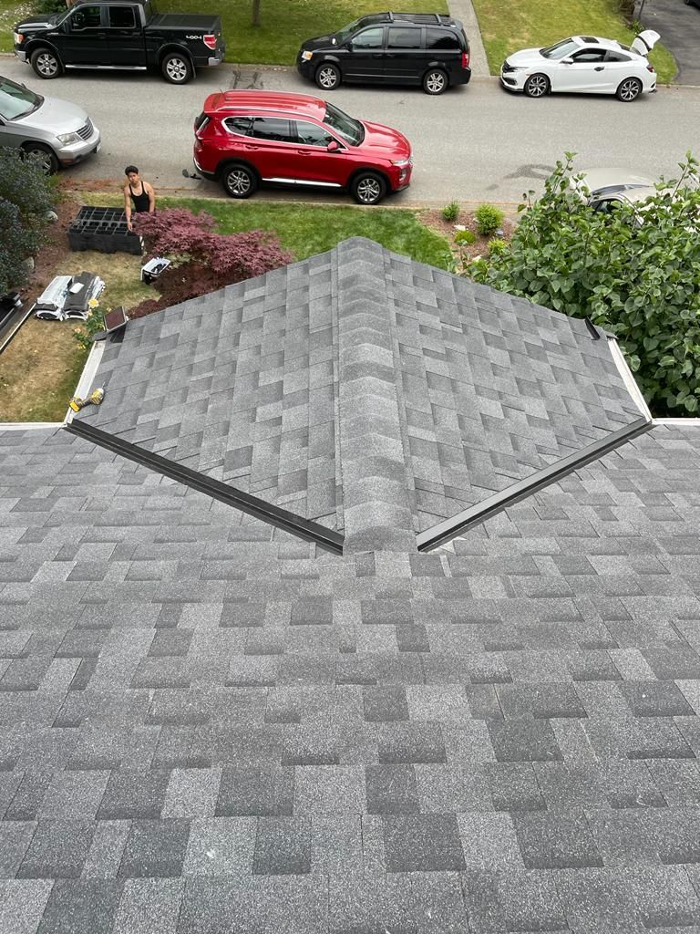 An aerial view of a roof with cars parked on the side of the road.