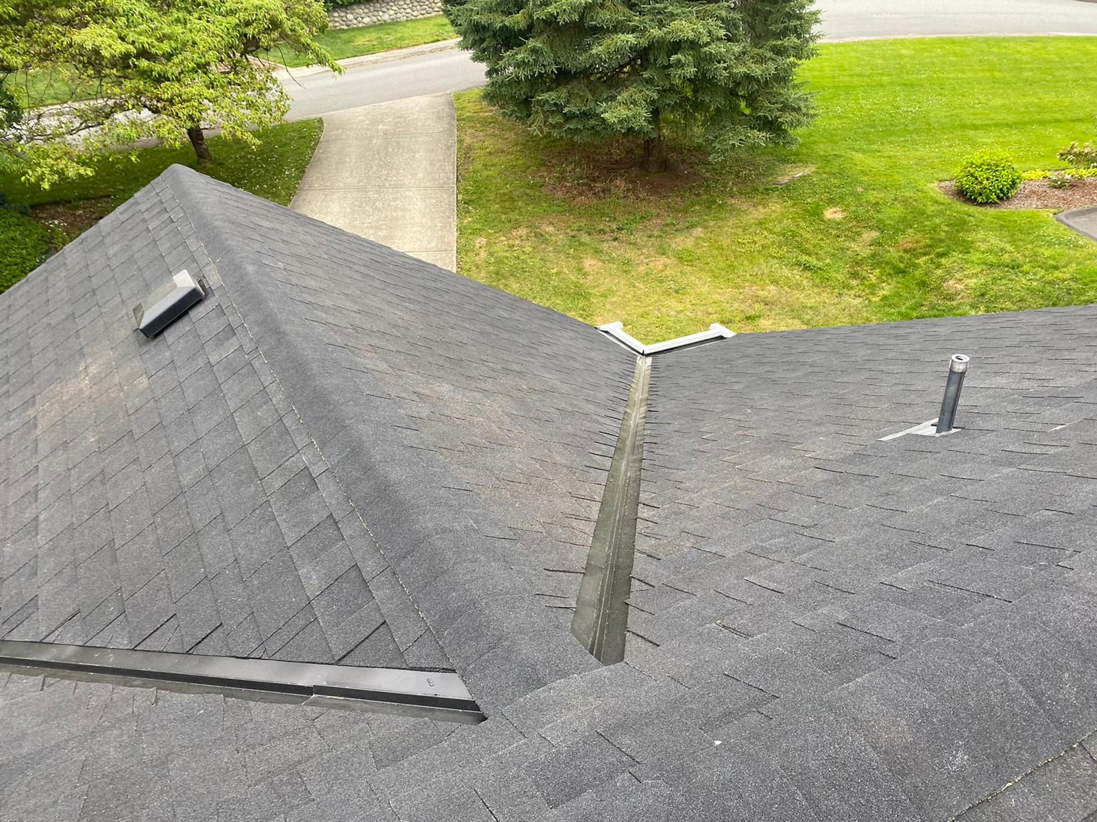 An aerial view of a roof with a gutter and a chimney.