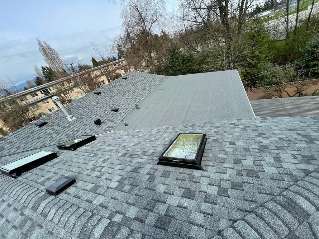 Completed roof replacement on a residential home in Richmond BC showing new architectural asphalt shingles installed by Paragon Roofing BC