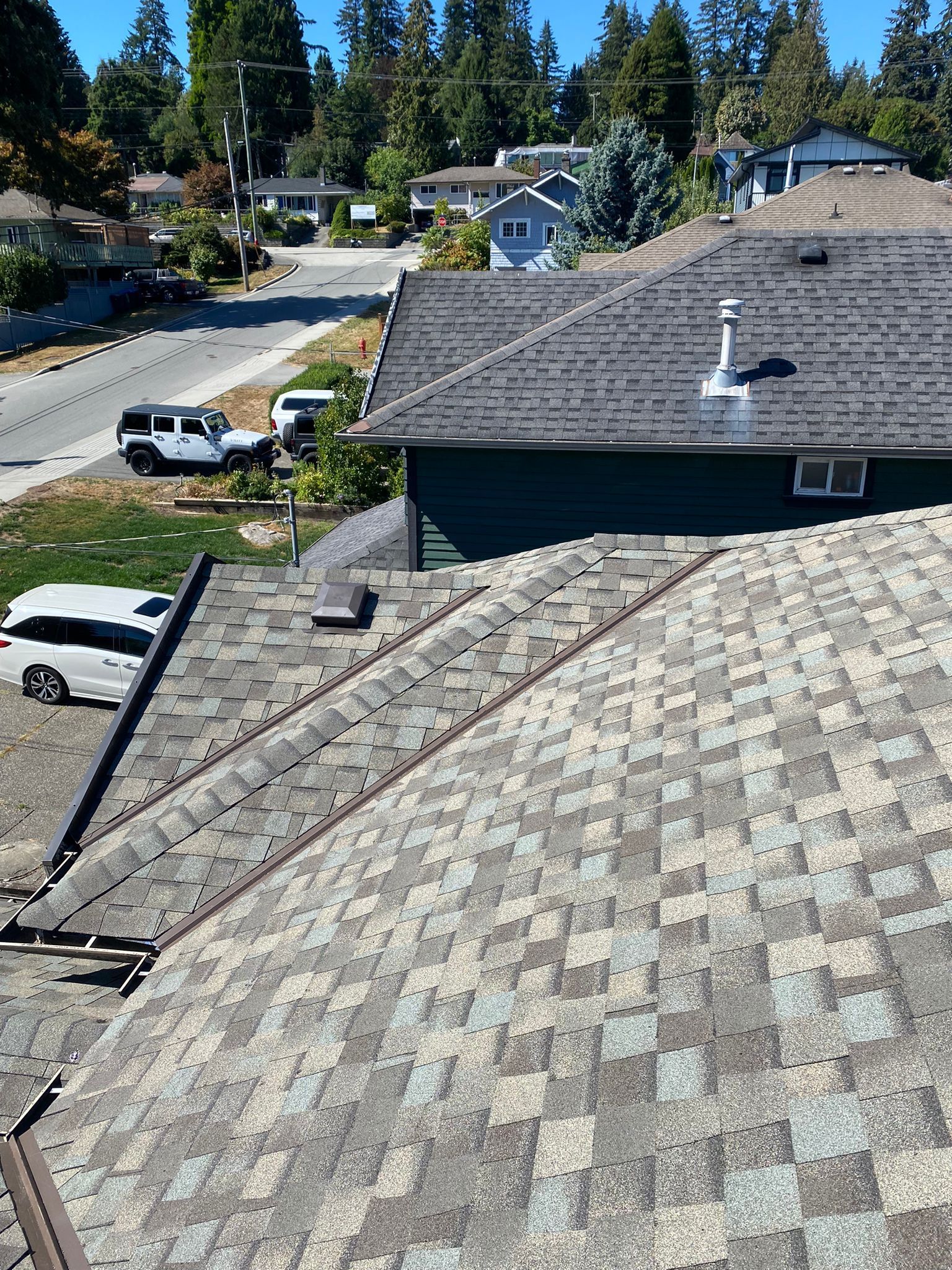 An aerial view of a roof of a house in a residential area roof done by paragon roofing