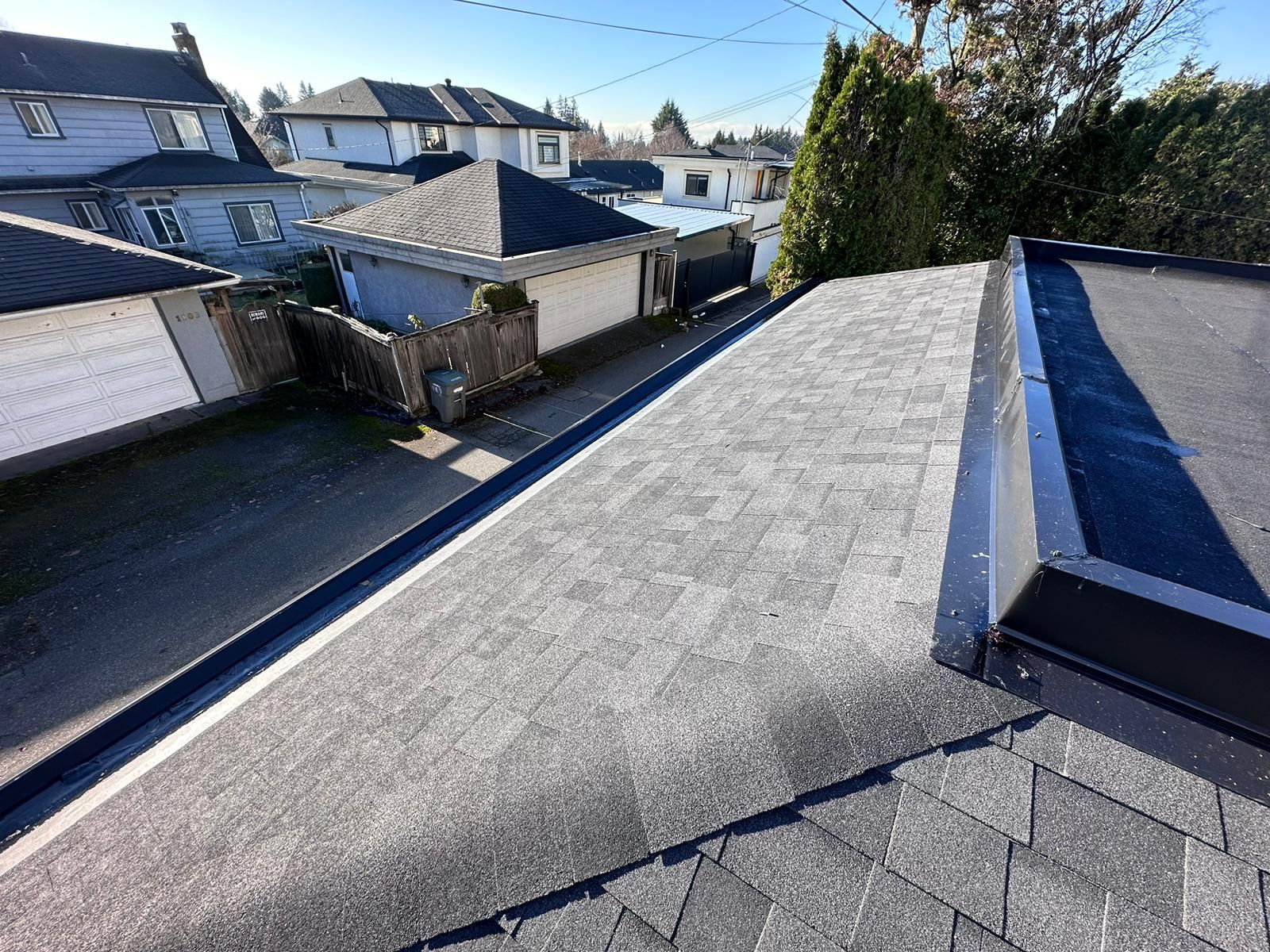 A roof of a house with a drain on the side of it.