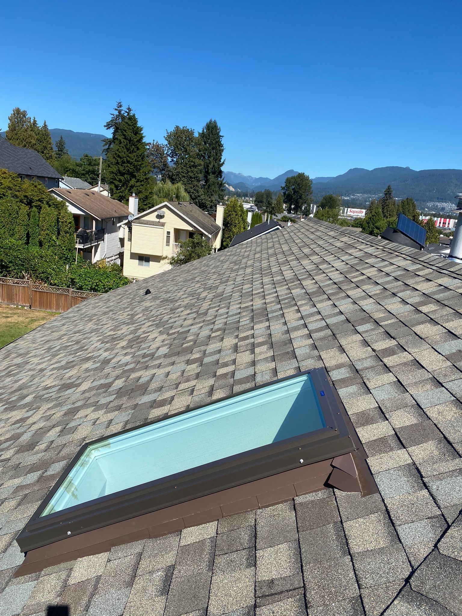 There is a skylight on the roof of a house.