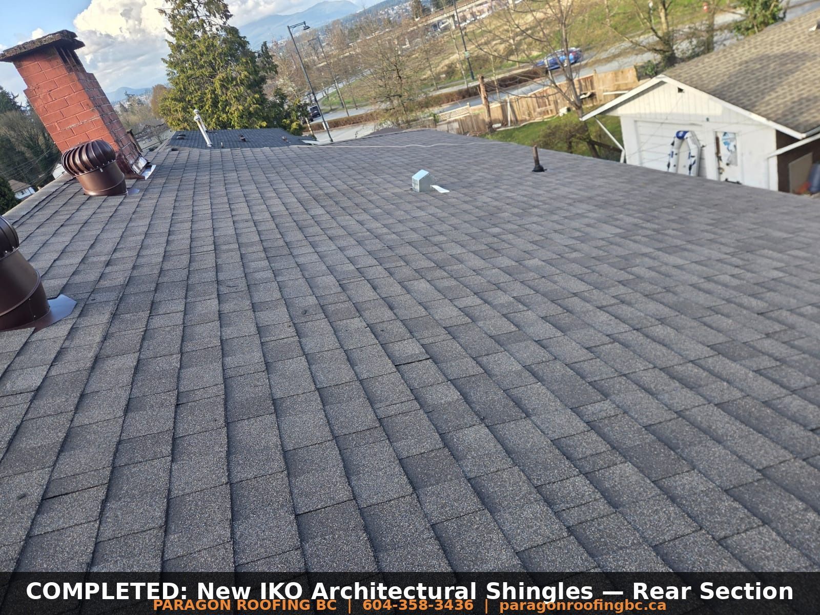 Completed new IKO architectural shingles installed on rear roof section with turbine vents — 133A St Surrey BC by Paragon Roofing BC