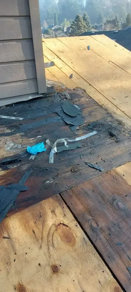 A wooden deck is being built on top of a house.