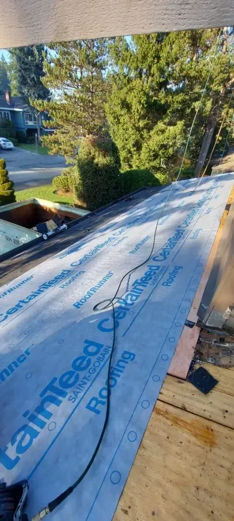 A roof is being built with a roofing material on it.