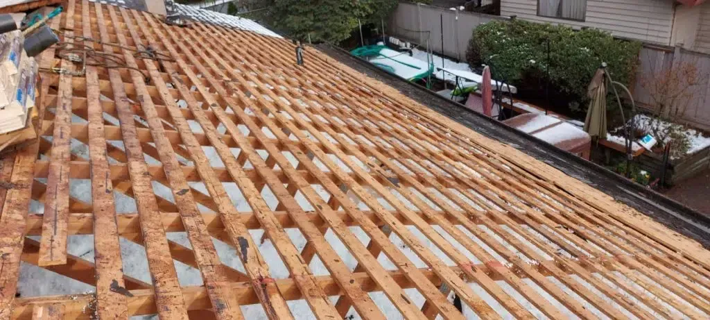 A wooden structure is being built on top of a roof.