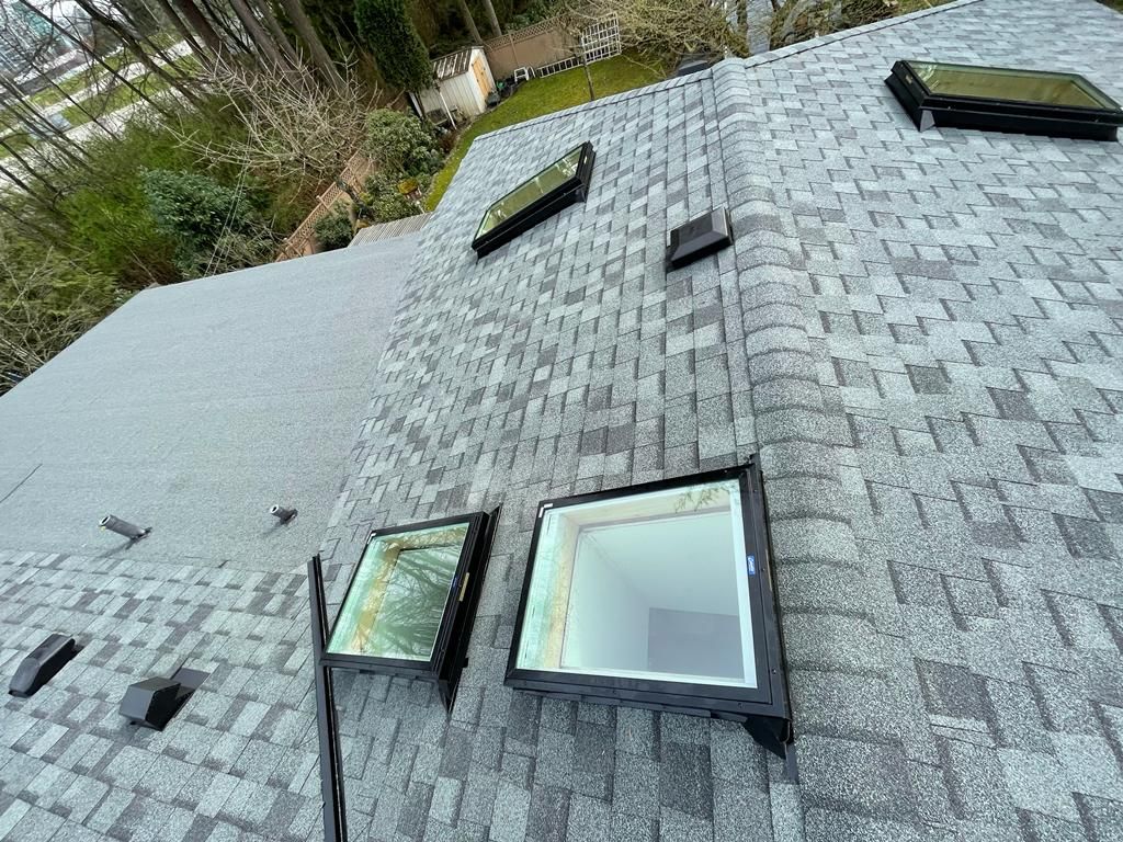 There are two skylights on the roof of a house.