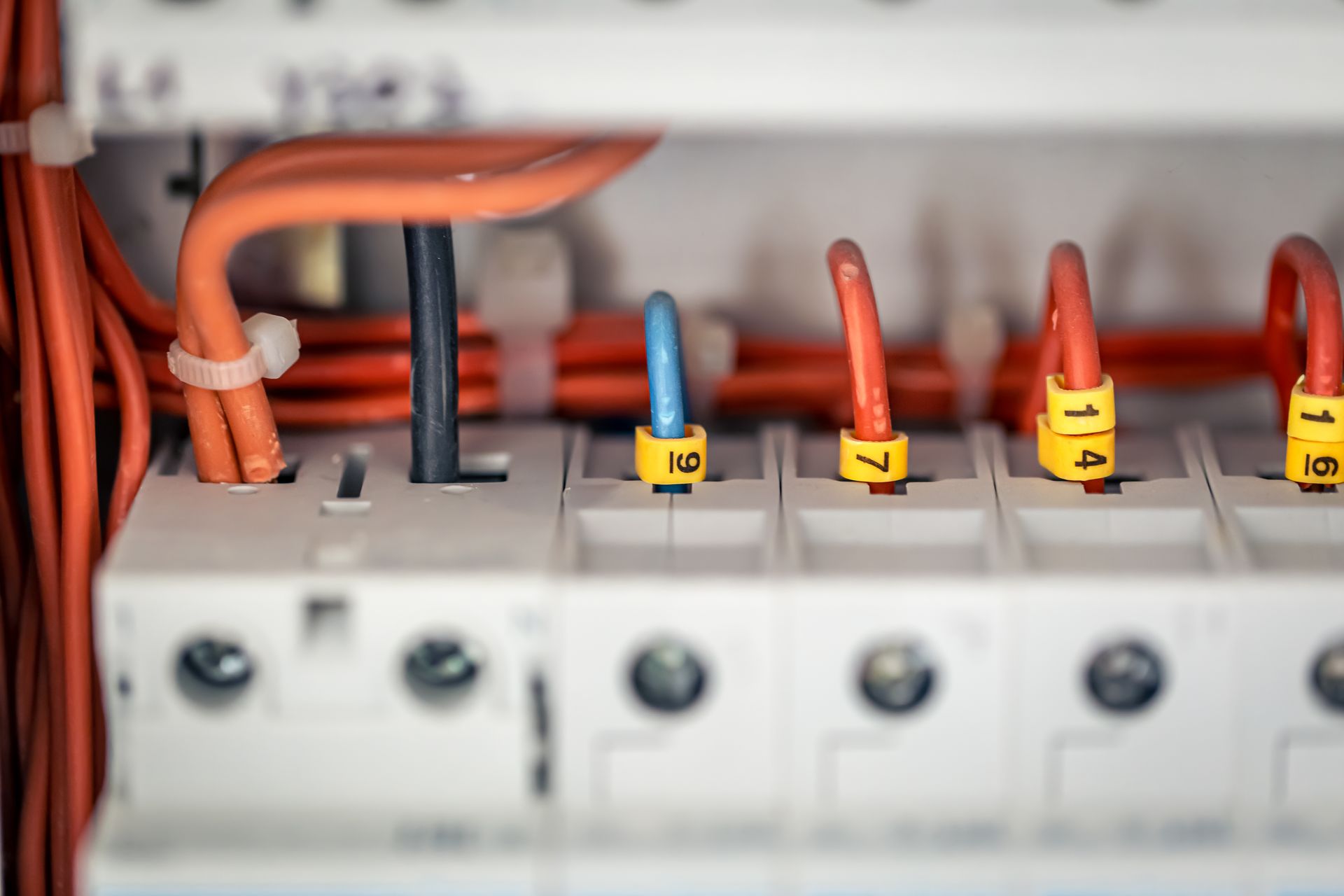 A close up of a electrical box with a bunch of wires coming out of it.