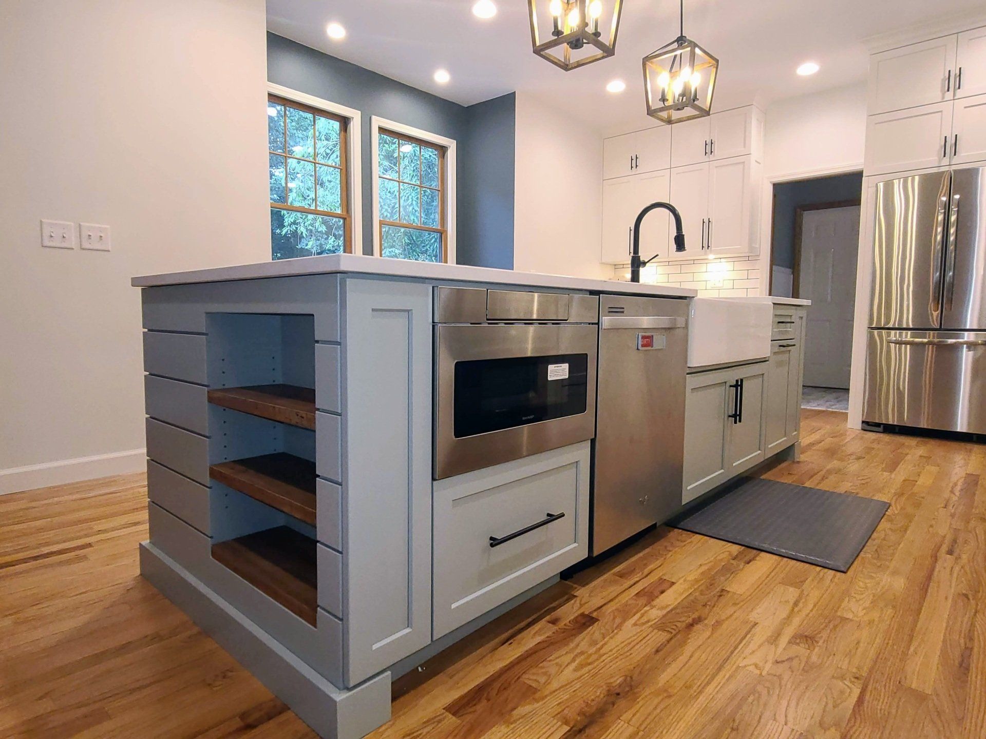 A kitchen with stainless steel appliances and a large island.