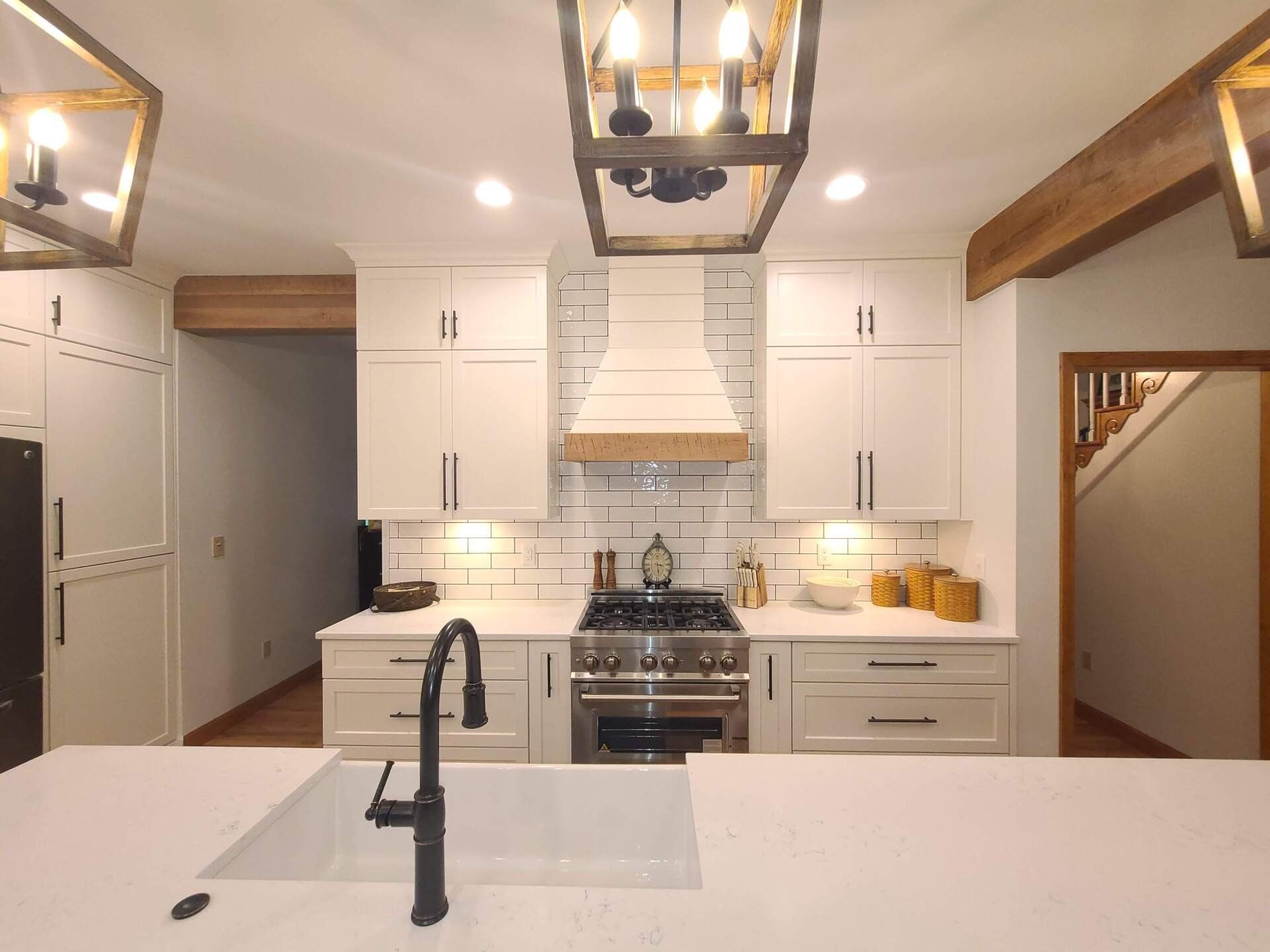 A kitchen with white cabinets and stainless steel appliances