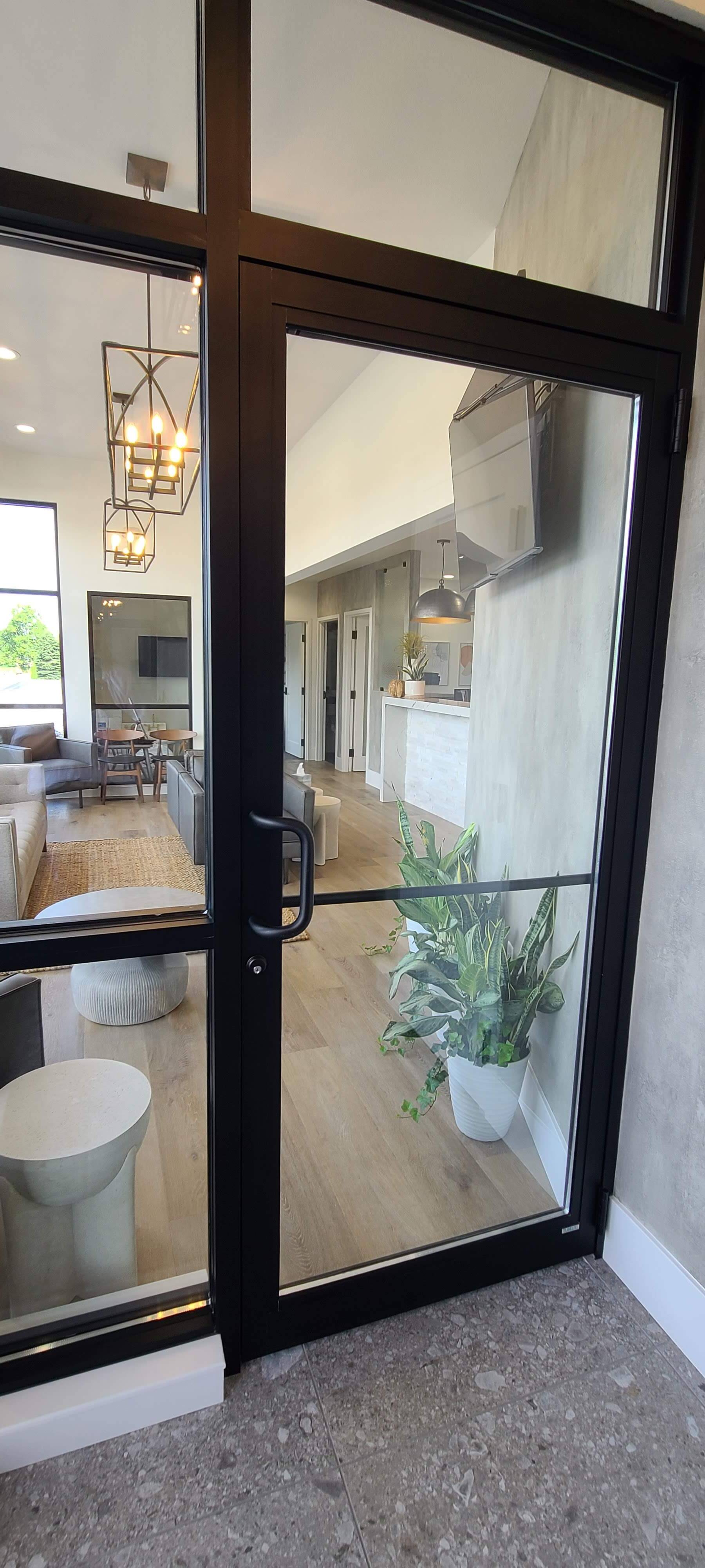 A glass door leading to a living room in a house.