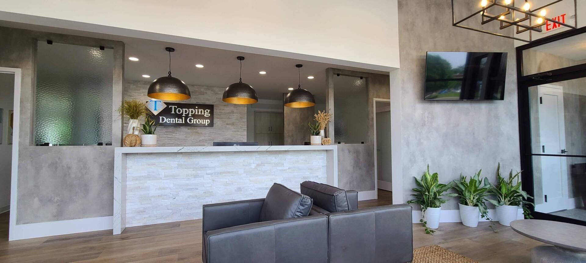 A living room with a couch , chair , and television.