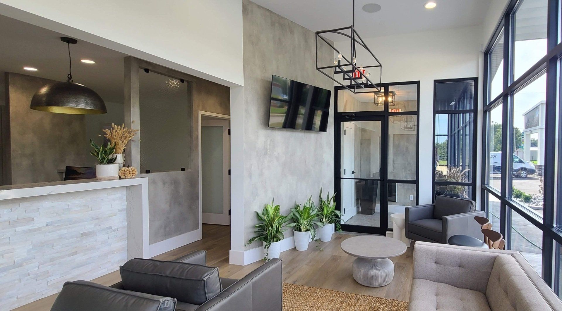 A living room with a couch , chairs , and a television.