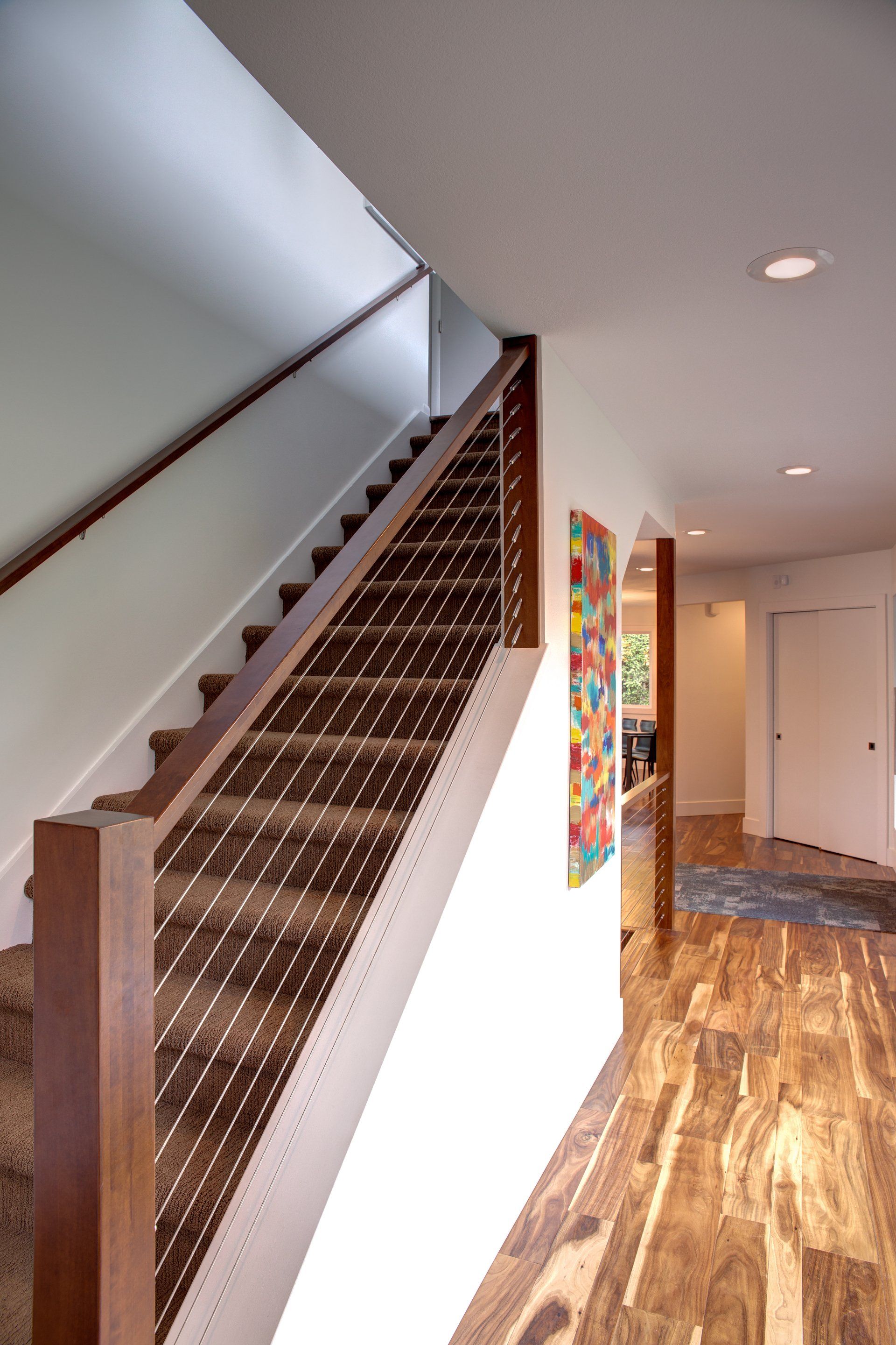 A staircase with a wooden railing in a hallway