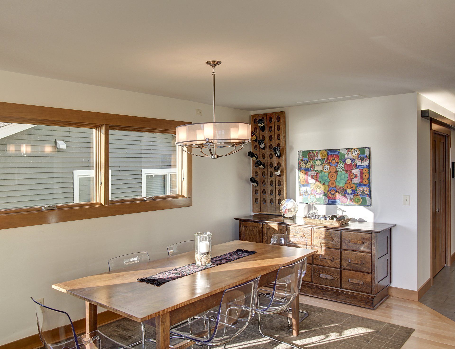 A dining room with a long wooden table and chairs