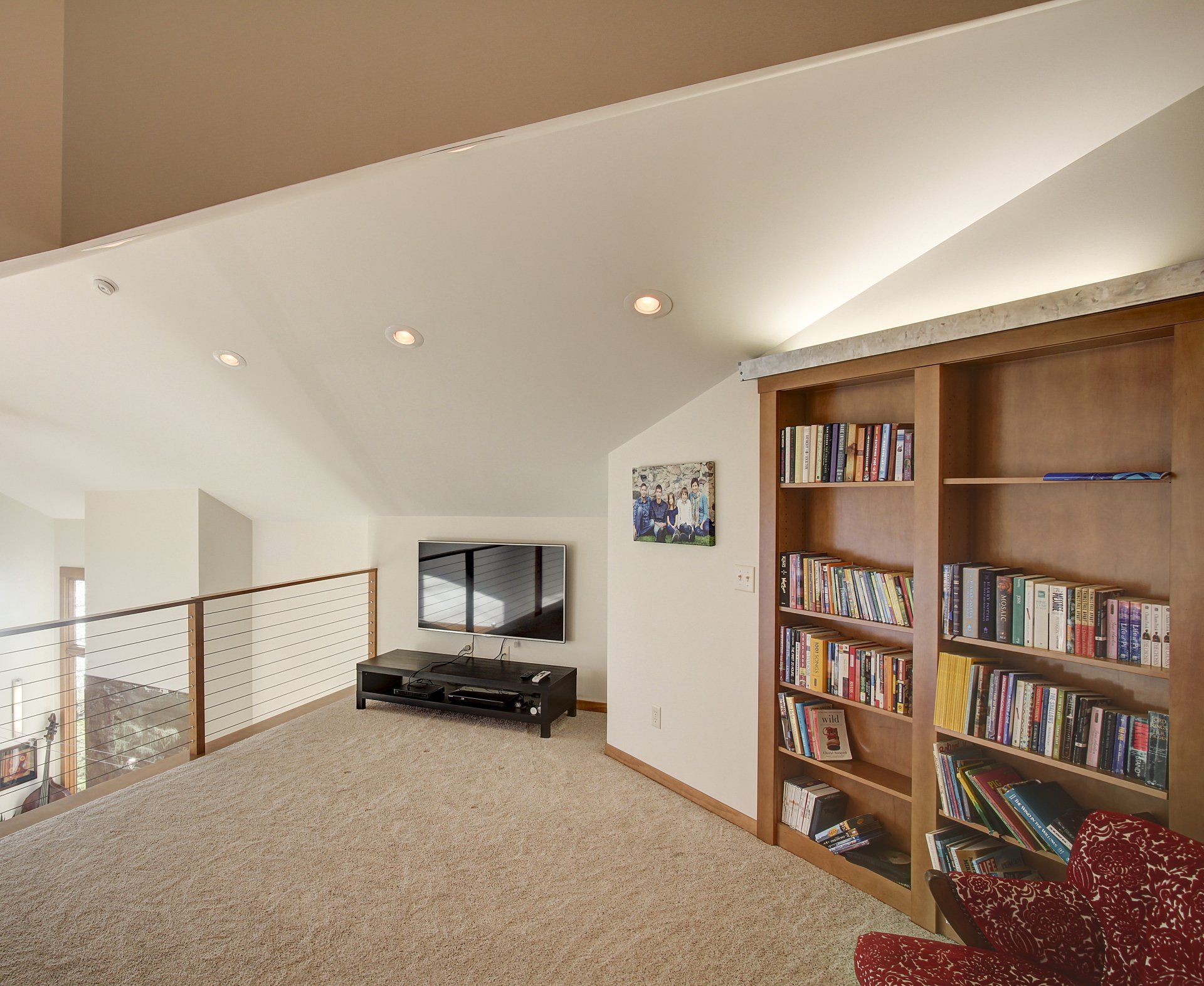 A living room with bookshelves and a flat screen tv