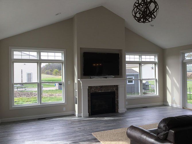 A living room with a fireplace and a flat screen tv