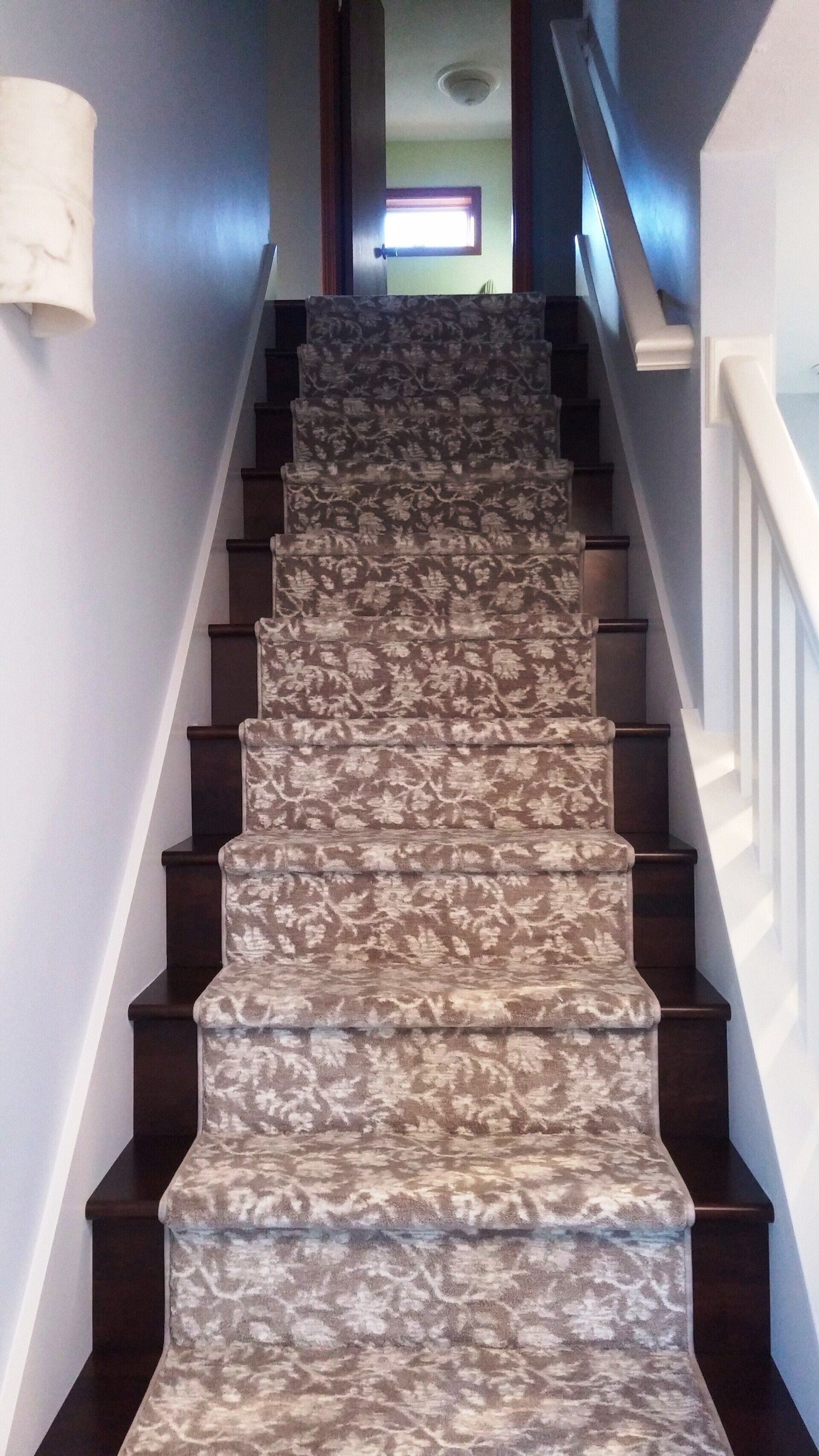 A set of stairs with a carpet on the steps