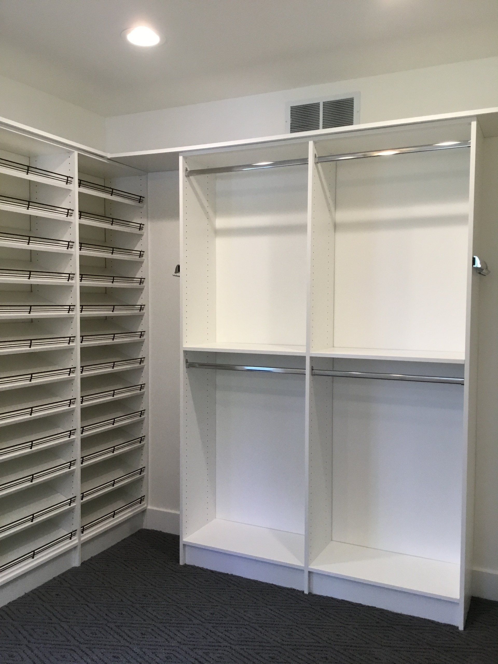 A walk in closet with lots of shelves and racks