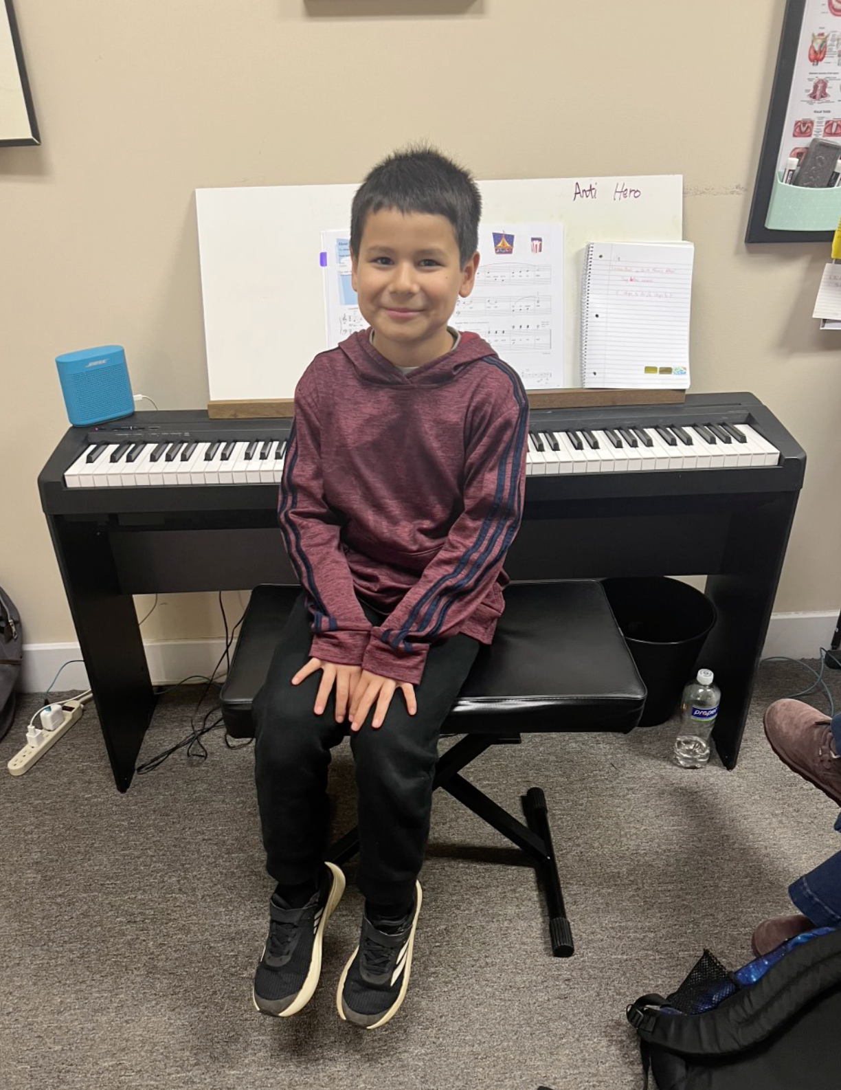 A young girl is playing a violin in a room.