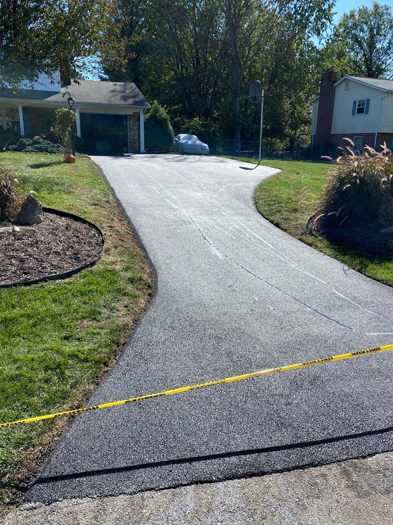 A newly paved driveway leading to a house