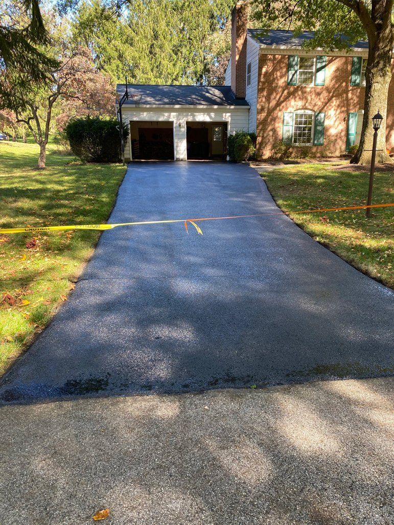 A driveway leading to a house with two garages
