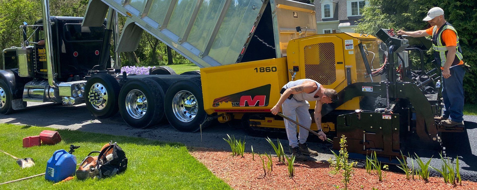 A man is working on a machine that says ' asphalt ' on it