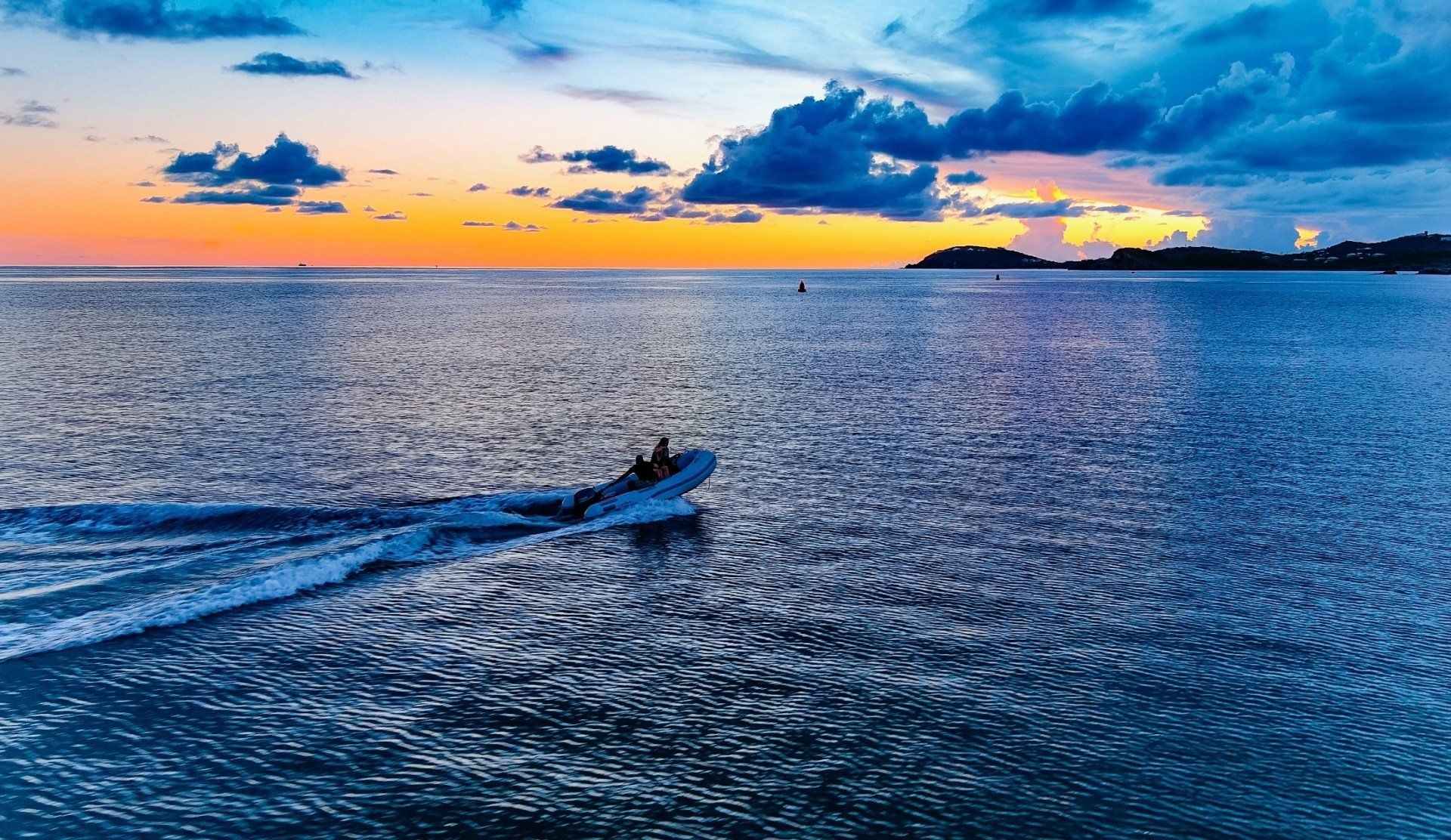 Aerial view of boat while in the middle of sunset