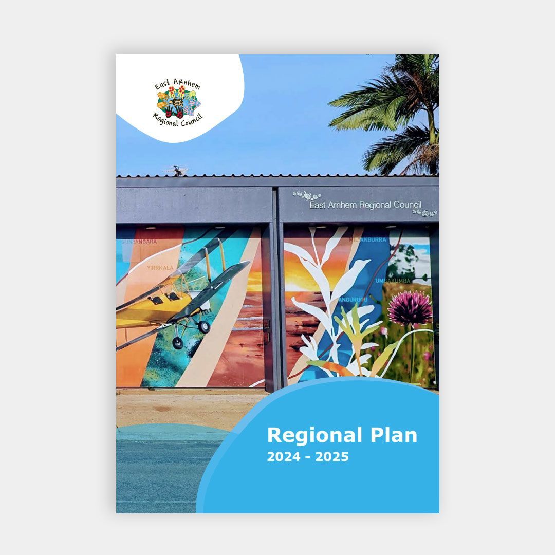 An image of an A4 booklet on a grey background. On the booklet is the title 'Regional Report' in the bottom right corner, the East Arnhem Regional Logo is in the top left corner and an image of East Arnhem Regional Council Building with a mural is the main image. 