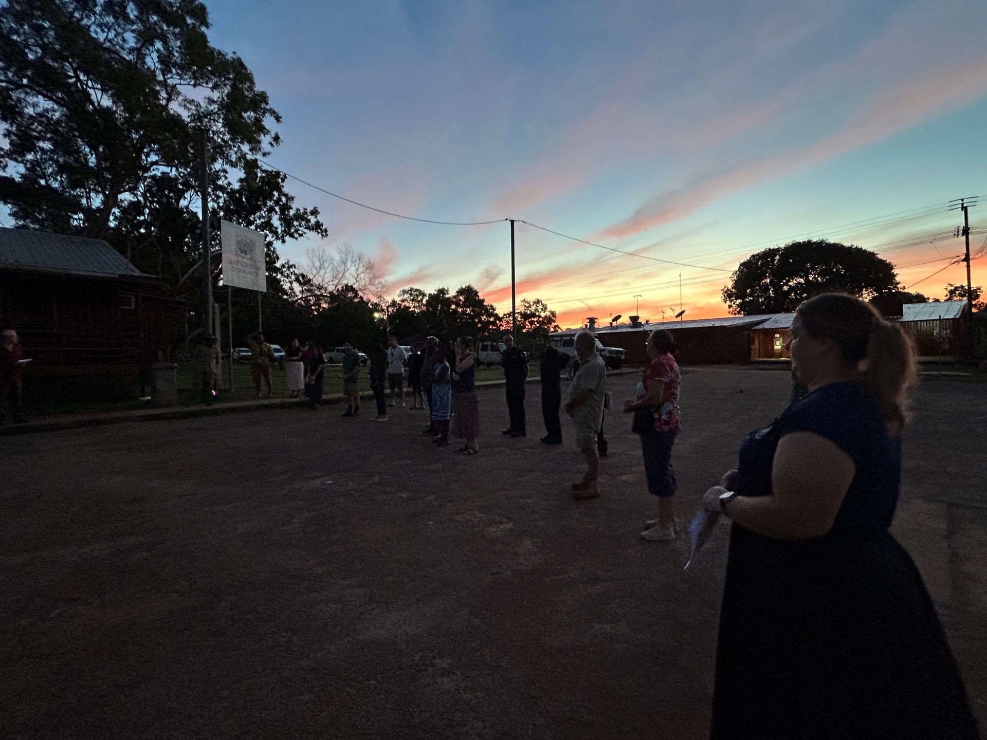 A group of people together at dawn