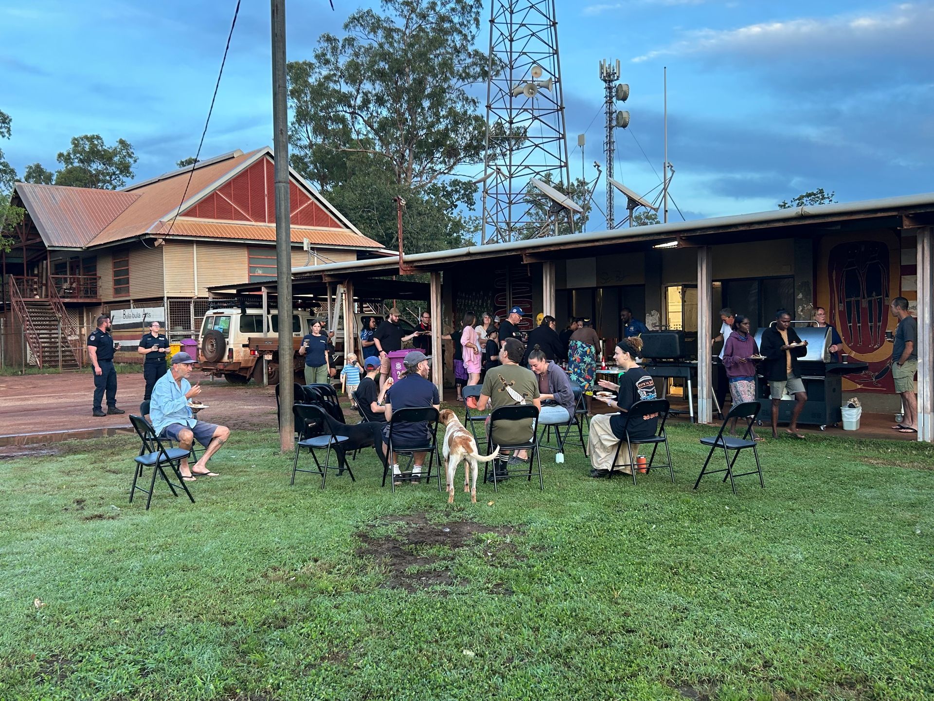 A group of people gather on the grass
