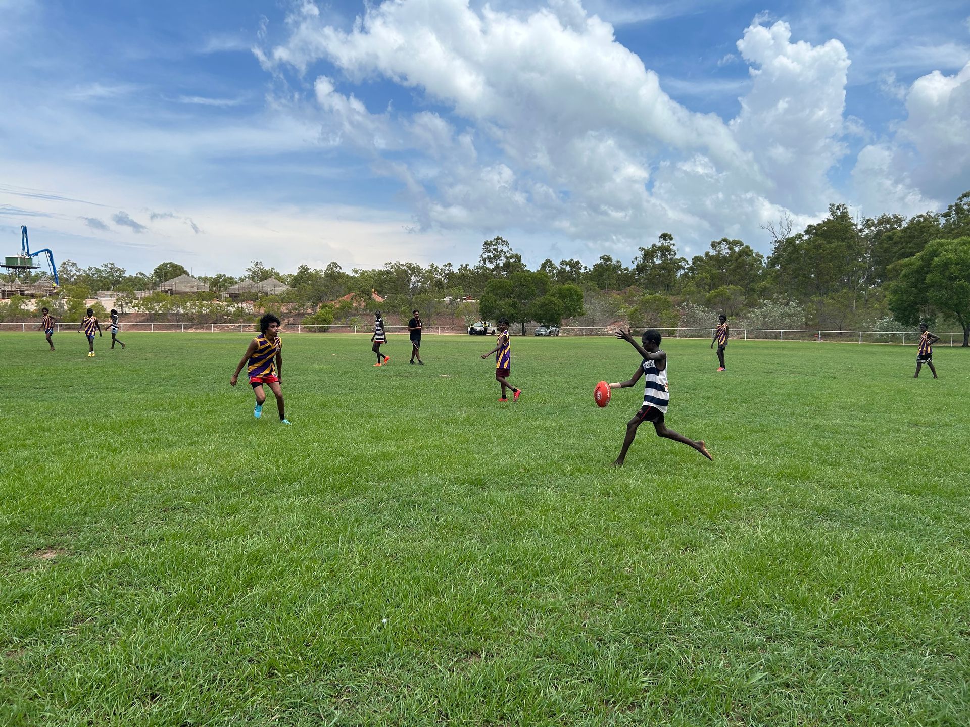 Youth playing ALF on an oval