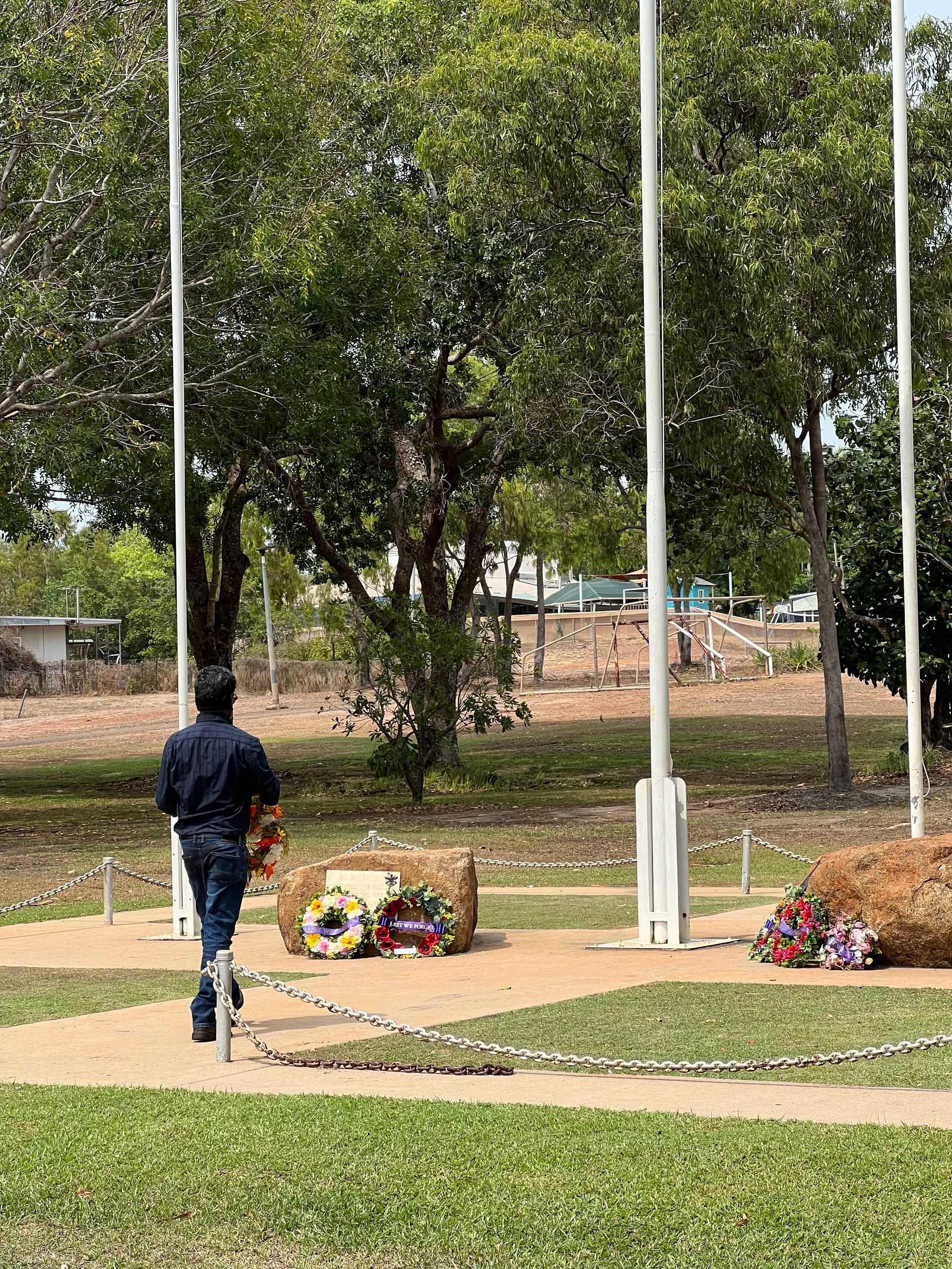 A man laying a wreath