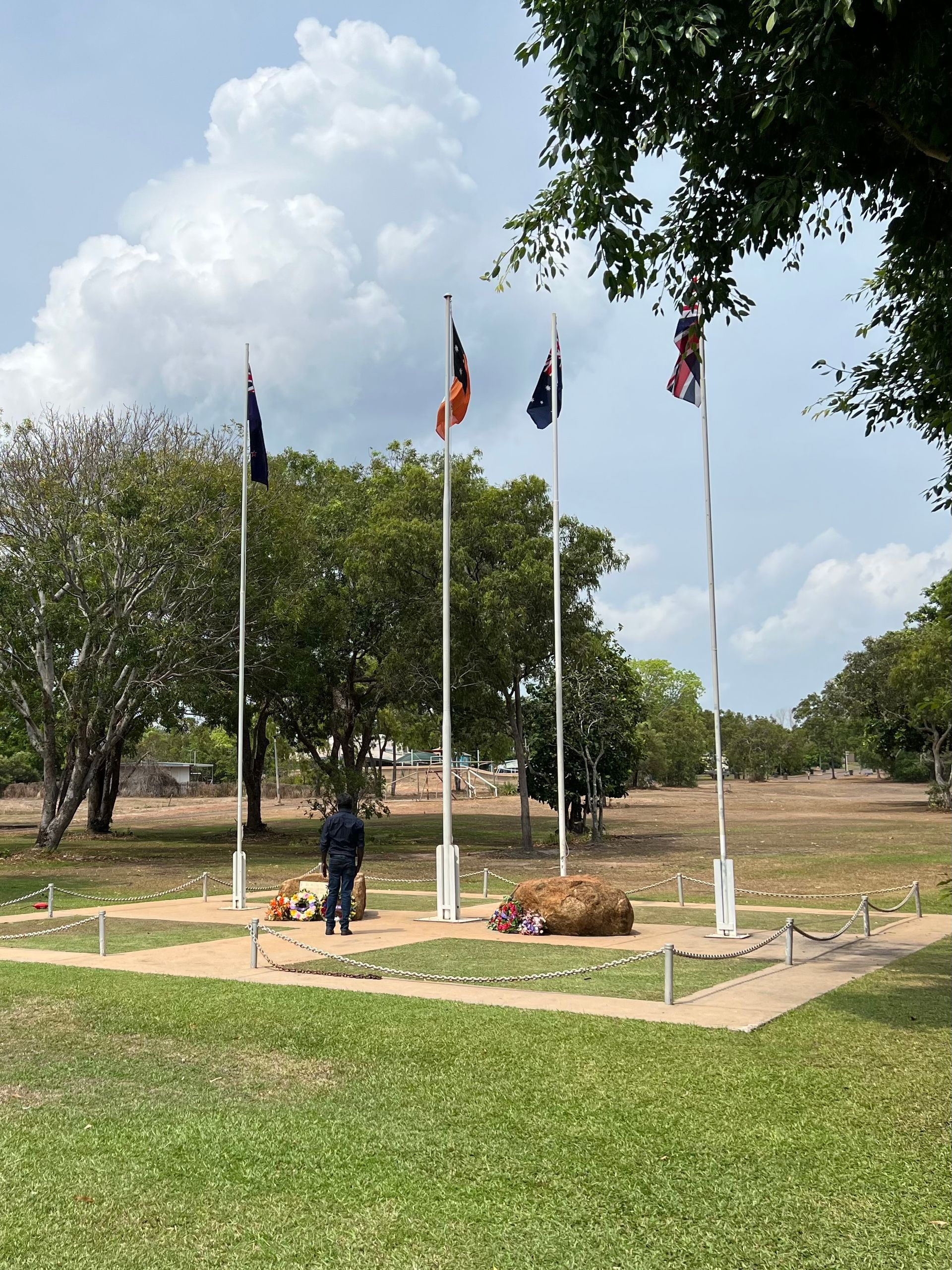 A man laying a wreath