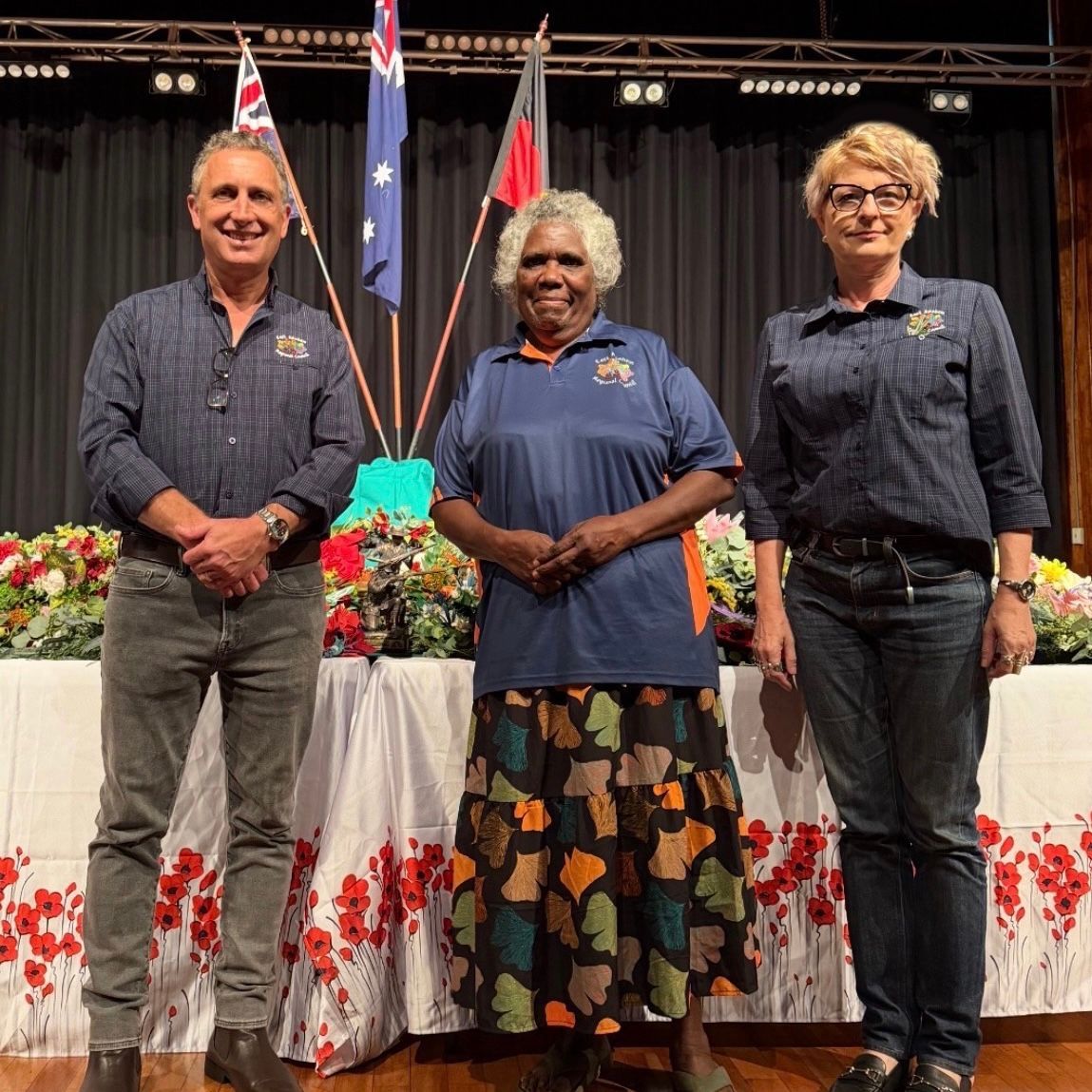 Three people standing together smiling