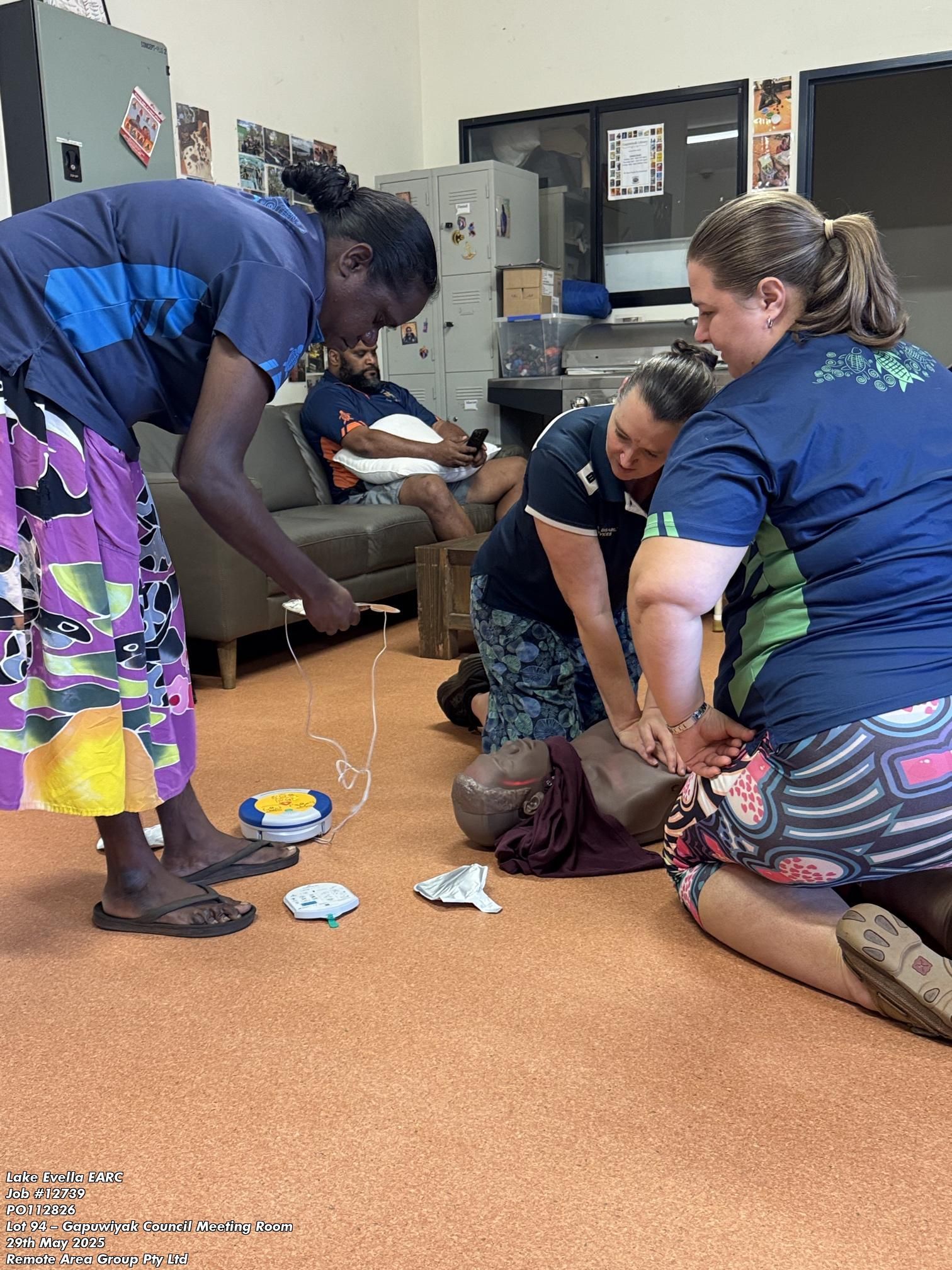 A group of three people practicing CPR