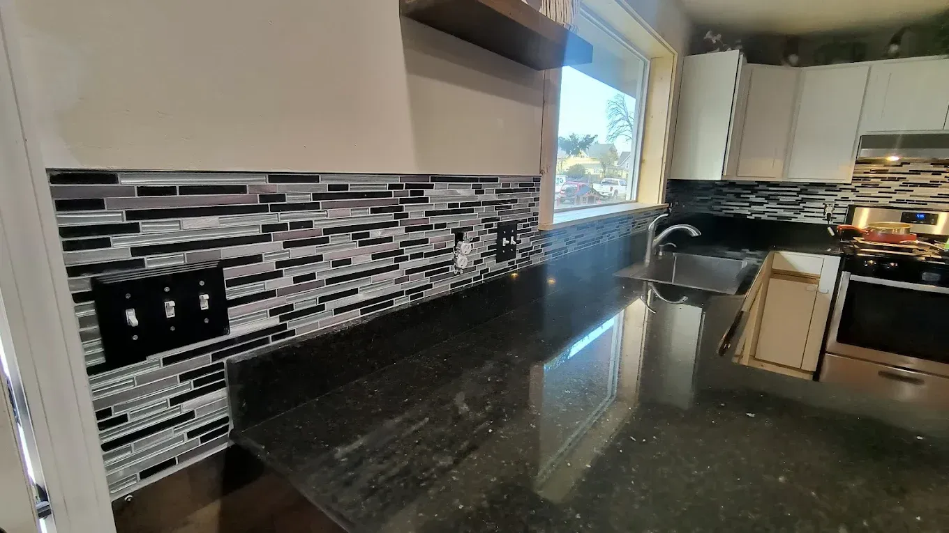 A group of people are painting a house.