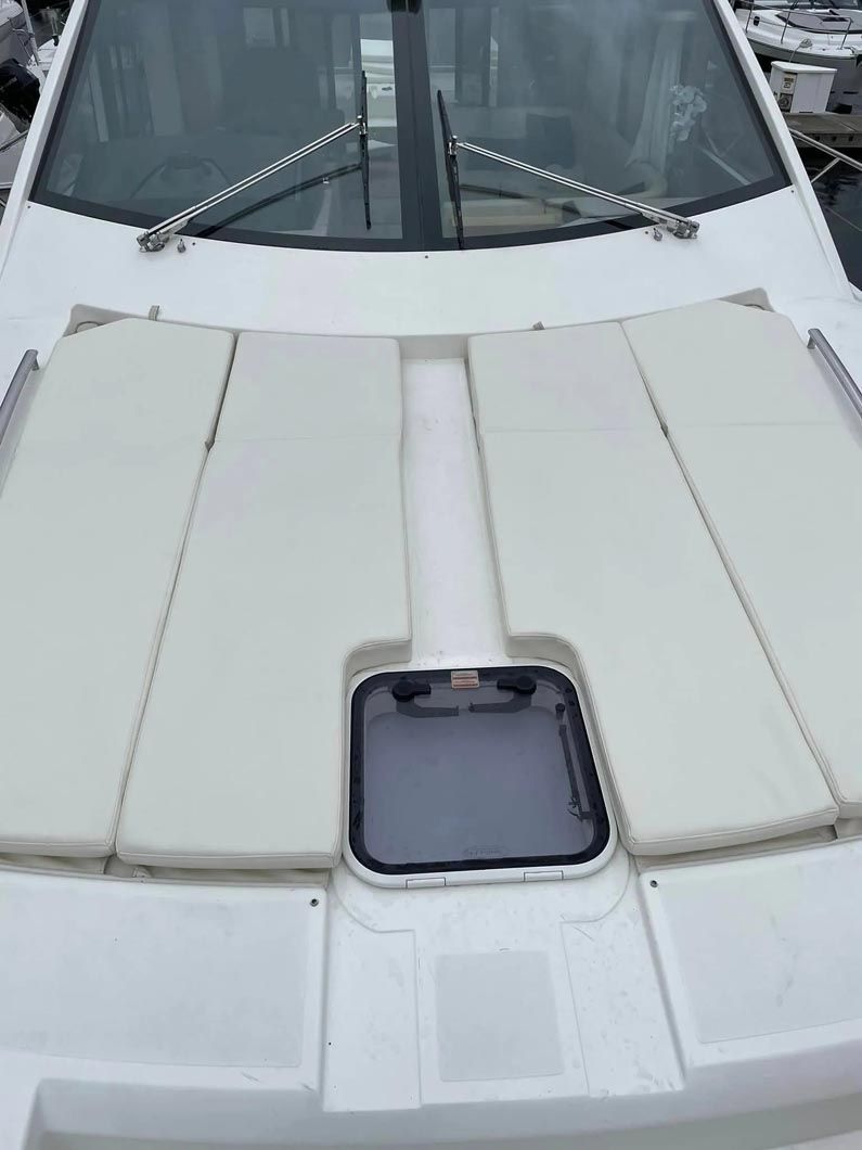 A close up of the hood of a white boat.