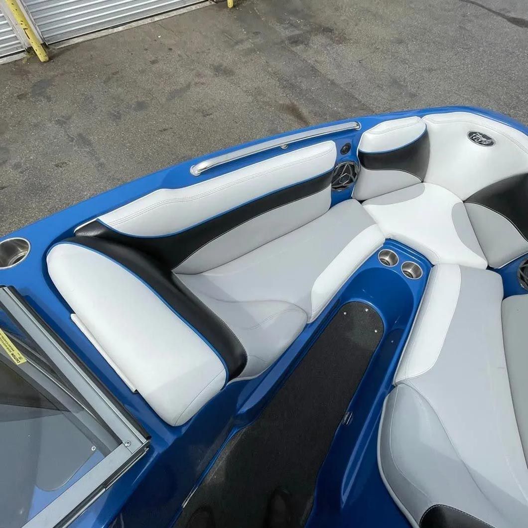 A blue boat with black and white seats