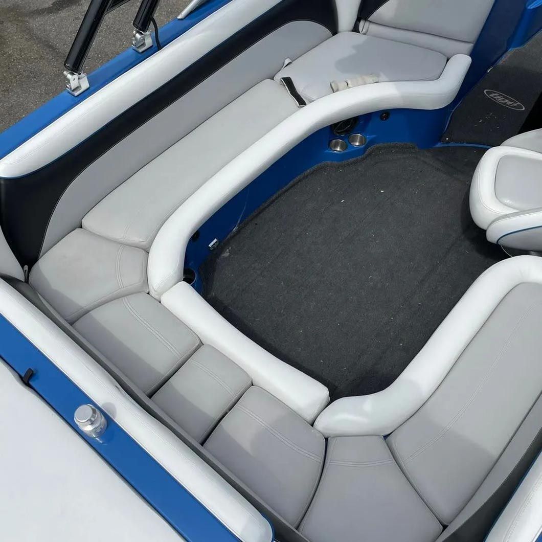 A blue and white boat with gray seats