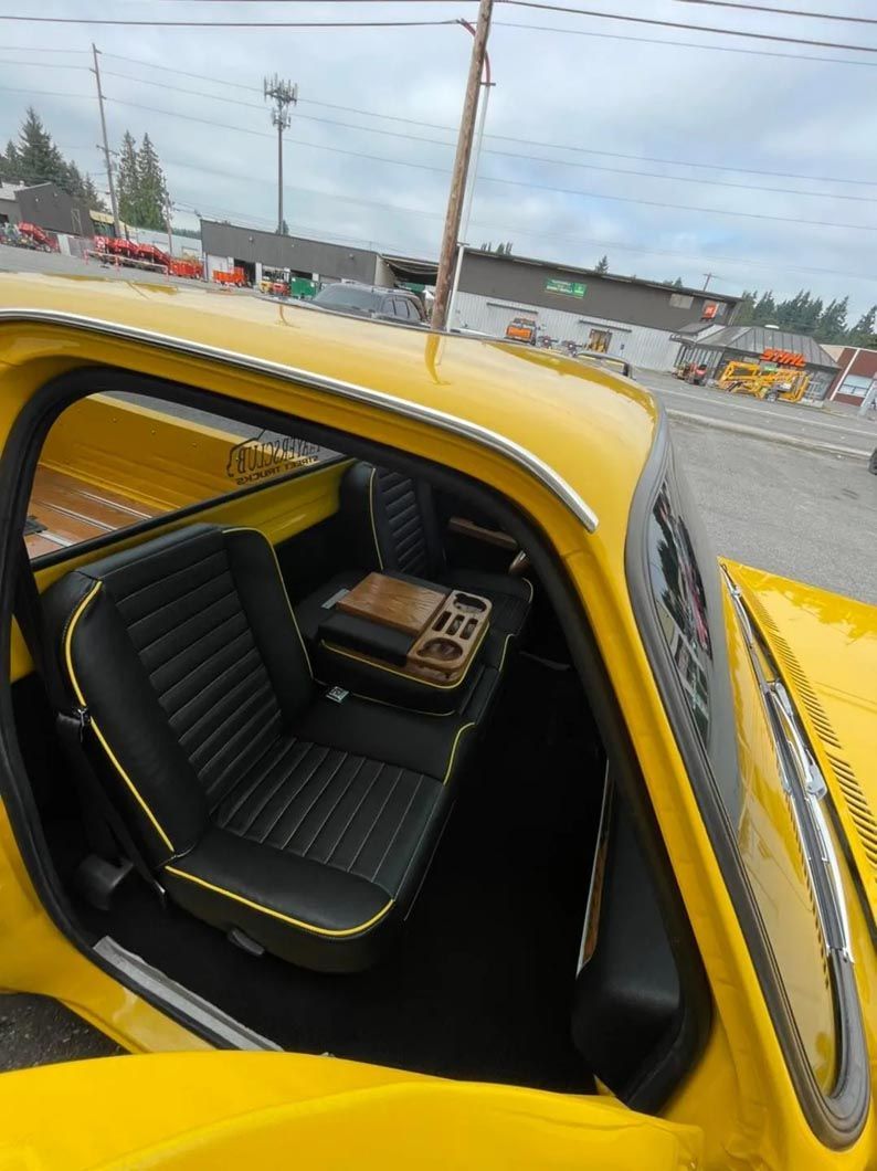 The inside of a yellow car with the door open