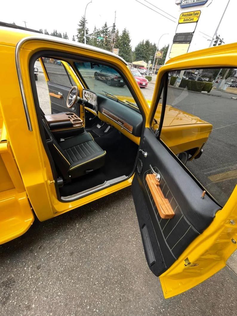 The inside of a yellow truck with the door open.