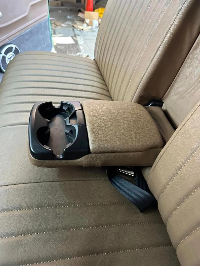 A car seat with a cup holder on the arm rest
